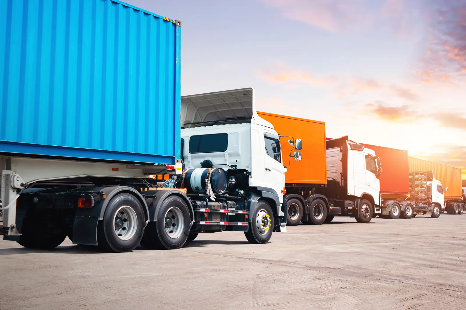 Row of container trucks at a logistics yard